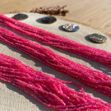 Load image into Gallery viewer, Czech Seed Bead 3Cut 10/0 Transparent Topaz/ Pink Lined Strung
